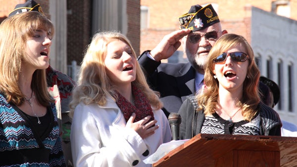 With Post 102 Commander Steve Vinson saluting in the background, the Eyes of Emiline perform the National Anthem at Monday’s Veterans Day ceremony in downtown Ahoskie. Staff Photo by Cal Bryant