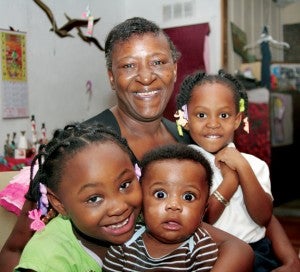 Lorraine Sanders-Ford poses with three of her grandchildren (from left) Amina Smallwood, Ryan Sanders, and Laila Smallwood at their home near Windsor.  Sanders-Ford lost everything in a house fire 11 months ago, but still wrote a poignant ‘Letter to Santa’ on behalf of the children. Staff Photo by Gene Motley