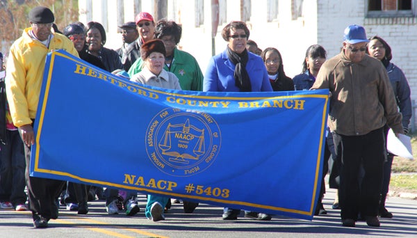 The Hertford County Chapter of the NAACP leads the way during Monday morning’s march down Martin Luther King Jr. Blvd. in Ahoskie towards a 12 noon gathering at New Ahoskie Baptist Church. Staff Photo by Cal Bryant 
