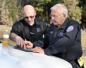 Northampton County Sheriff’s Captain Chuck Hasty (left) and CERT leader Mac Morgan study a map of the wooded area to be searched. Staff Photo by Cal Bryant
