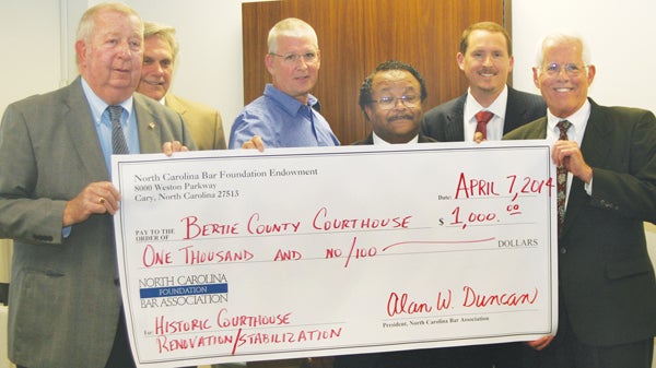 Members of the Bertie County Board of Commissioners accept a $1,000 check presented to the county from the NC Bar Association Foundation Endowment Fund to assist with renovations to the Bertie County Courthouse. Posing with the check are (from left) Commissioners J. Wallace Perry, John Trent, Rick Harrell, and Charles Smith, Assistant County Attorney Jonathan Huddleston, and Tom Hull of the NC Bar Association Foundation. Staff Photo by Gene Motley