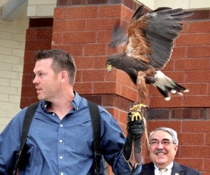 It was only fitting that a peregrine falcon, shown here perched on the arm of its owner, Chip Gentry, took part in the dedication of the new Bertie High School on Sunday. Staff Photo by Cal Bryant