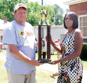 Ernest Twisdale of Roanoke Rapids was crowned as the 2014 champion chef at the Roanoke-Chowan Pork Fest. Making the trophy presentation is Amy Gillus of Rivers Correction, one of the event’s corporate sponsors. Staff Photo by Cal Bryant