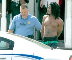 Following his arrest at a Lloyd Street residence on Tuesday, Dytwan Donnelle Chamblee is led away in handcuffs by Ahoskie Police Major Jimmy Asbell. Staff Photo by Cal Bryant 