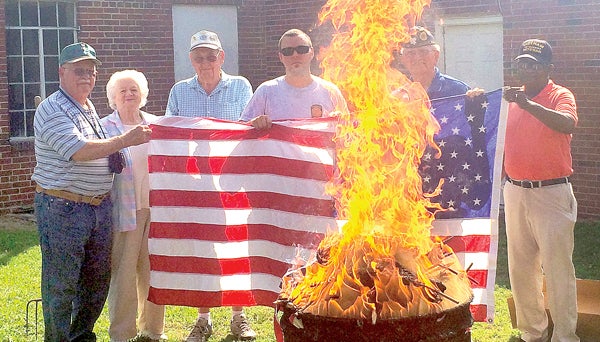 From left, William Godwin, Rebecca Godwin, Ned Knepper, Nathan Pierce, James Hutchinson and William Winfield take part in a Flag Retirement ceremony held Wednesday at Hertford County American Legion Post 102. Staff Photo by Caslee Sims 