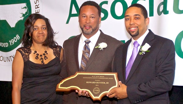 Howard Hunter III (center) accepts the 2014 North Carolina County Commissioner of the Year Award from Ray Jeffers, outgoing President of the North Carolina Association of County Commissioners. Also pictured is Hunter’s wife, Dr. Wanda Hunter. Photo courtesy of NCACC 