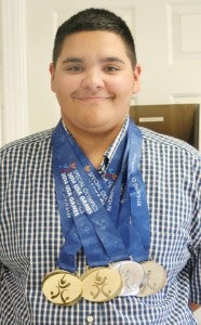 Hertford County Middle School student-athlete Storm Hall shows off the two gold and two silver medals won at the USA Games in Princeton, NJ in June. Hall was a medalist in shot put, 100-meter run, mini-javelin toss, and the long jump. Staff Photo by Gene Motley