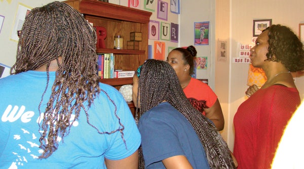 Denita Eley shows the volunteers the Reading Readiness Room, part of the Esquires for Education Inc. program aimed at improving the educational skills of young African-Americans. Contributed Photo