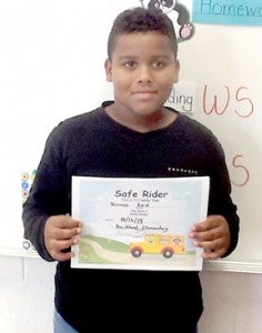 Buckland Elementary student Terence Reid Jr. proudly displays a “Safe Rider” certificate awarded for his heroic actions last week when his bus driver became ill.