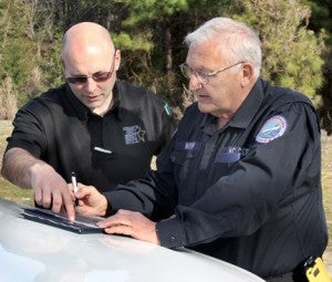 Northampton County Sheriff’s Captain Chuck Hasty (left) and CERT leader Mac Morgan study a map of a wooded area searched earlier this year in the case of a missing man. Hasty was named earlier this week as the new Police Chief in Roanoke Rapids. File Photo