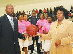 Bertie High girl’s basketball coach Alice Lyons poses with her son and assistant coach, former ECU player, Lester Lyons (left), as the Lady Falcons basketball team celebrate Lyons’ 700 wins prior to Friday’s game in Windsor. Staff Photo by Gene Motley