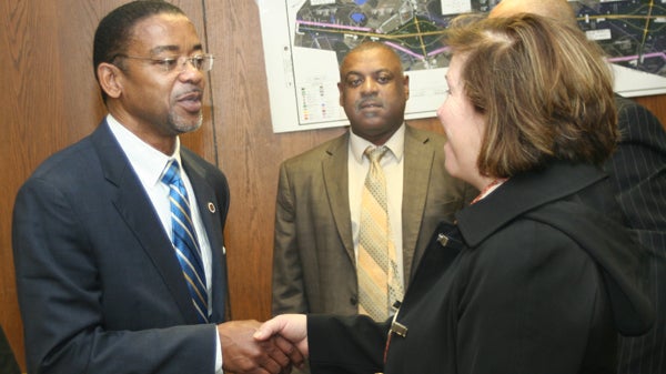 Newly sworn-in Hertford County Commissioner Garry Lewter (left) is greeted by Amy Braswell, Executive Vice-President of the Ahoskie Chamber of Commerce, at Monday’s board meeting. Shown in the background is Commission Vice Chairman Ronald Gatling. Staff Photo by Gene Motley