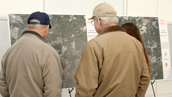 Property owners study a map of the proposed route of the Atlantic Coast Pipeline through Northampton County at a January workshop hosted by project officials in Jackson. Staff Photo by Cal Bryant
