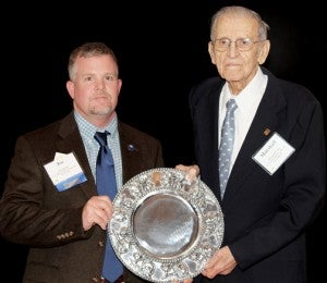 Joe Martin (left), Conway cotton producer and President of the North Carolina Cotton Producers Association, presents Marshall Grant the association's inaugural "White Gold" award after Grant made a few words of appreciation to the crowd attending the awards ceremony during the 26th Annual Joint Commodities Conference, Jan. 14-16 in Durham. Contributed Photo