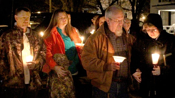 Members of the Ruby Baker family – top photo: from left, Michael and Crystal Lassiter (granddaughter of Mrs. Baker), and Mitch and Mary Lou (daughter) Byrum; bottom photo in foreground: great granddaughters Bray Roberson (left) and Haley Meeks  – take part in Monday’s candlelight ceremony in memory of the Ahoskie woman murdered one year ago. Staff Photos by Cal Bryant