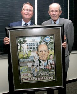 In 2008, Chowan University paid tribute to Jim Garrison by renaming its Sports Hall of Fame, in which he was inducted in 1987, in his honor. Coach Garrison is shown here receiving an artistic montage of his life’s work from Chowan President Dr. Chris White. File Photo by Cal Bryant