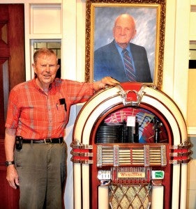 Brinson Paul stands with a vintage Wurlitzer jukebox, among the 13,000-plus on display in the Brady Jefcoat Museum in Murfreesboro. Mr. Jefcoat is shown in the portrait. Photo by Tim Flanagan