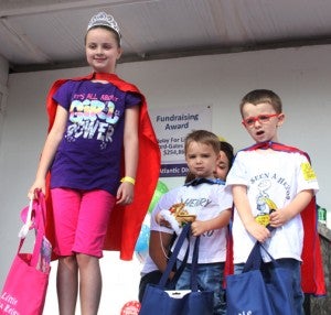 From left, Carly Piland, Daniel Hodges and Henry Hodges were respectively crowned Little Miss and Little Mr. Relay on Saturday morning. Each was recognized as the top fundraisers for the Kid’s Walk portion of Relay. Staff Photo by Cal Bryant