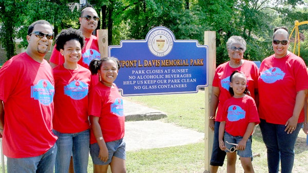 Members of the Dupont Davis family pose at the park sign following Saturday’s dedication service. Attending were (from left) Chris King, Shaniah King, Christian King, Dexter Davis, Camryn King, Earlene Davis, Dedria David-King, and Joyce Davis Smith. Staff Photo by Gene Motley