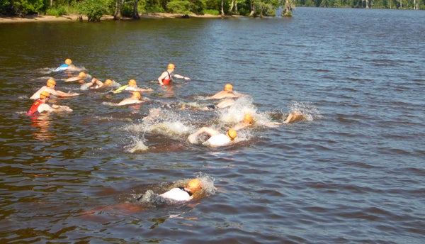 More than 100 athletes participated in the first-ever “Pound the Sound” triathlon at Scotch Hall Preserve in Merry Hill.  Here the men's group begins the competition of swim, bike, and run with a half-mile swim around Salmon Creek. Photo by JW “Russ” Russell