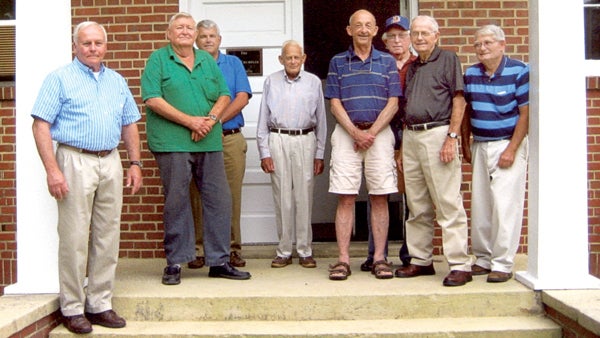 From left, Dave Farnham, Jesse Edward “Tink” Vaughan, Bob Lee, Gene Harden, John P. Revelle, Frank Stephenson, Percy Bunch and Colon Ballance stand on the steps of the newly christened H.B. Crumpler Building on the campus of the old Murfreesboro High School. Contributed Photo 