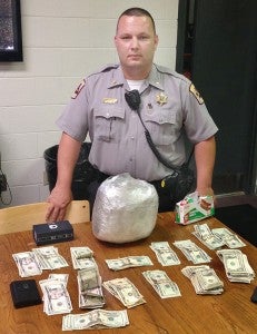 Hertford County Sheriff’s Deputy Chase Oliver stands with over five pounds of pot, drug paraphernalia, and nearly $1,500 in cash he seized during a recent traffic stop on NC 11. Photo contributed by HC Sheriff’s Office