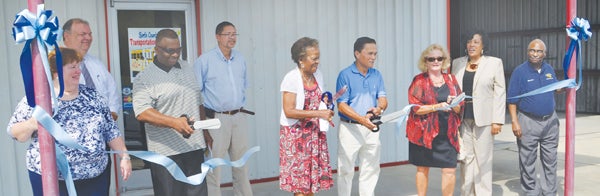 Bertie County Schools personnel join members of the Board of Education at the ribbon cutting of the school system’s new school bus garage. From left are Robin Russell (TIMS Coordinator), William Ledford (Transportation Director), Barry McGlone (BOE member), Matthew Bond (BCS Maintenance Dir.), Emma Johnson, Bobby Occena, and Jo Davis Johnson (BOE members), Superintendent Elaine White, and Melvin Wilson (Cost Clerk). Contributed Photo