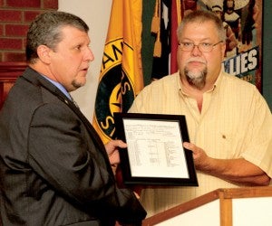 David Thompson (left), assigned National Director of Albemarle District Ruritan, presents Terry Johnson with a copy of the original Sunbury Ruritan Club’s Charter. Staff Photo by Cal Bryant