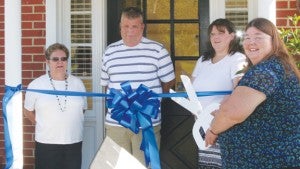 Askewville Mayor Gloria Bryant (right) prepares to cut the ribbon for the grand opening of the new Town Hall & Museum in a Saturday morning ceremony.  The building is the location of the former Southern Bank on Askewville Street.  Also on hand for the ribbon-cutting were Town Commissioners (from left) Kay Brantley, Mike Baker, and Carla Pesce. Staff Photo by Gene Motley