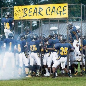 Members of the Hertford County High School varsity football team are poised to race out of the “Bear Cage” prior to the start of last Friday night’s home game. The cage is courtesy of several local businesses and the Hertford County Football Boosters. Photo by Gina Hoggard