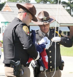 Two members of the Northampton County Sheriff’s Office Color Guard prepare to hoist the new flag for the first time above the Conway Volunteer Fire Department. Staff Photo by Cal Bryant