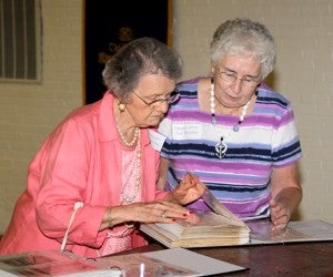 Dot Newsome (left) and Margaret Wynn take a walk down memory lane as they view a scrapbook of Ahoskie Kiwanis Club memorabilia during Saturday’s 90th anniversary celebration. Newsome and Wynn were two of the original three women to join the club in 1993. Staff Photo by Cal Bryant