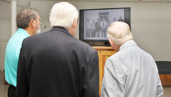 From left, Ahoskie Kiwanis Club members J.E. Benton, Bob Newsome (retired) and E.L. Holloman watch a video featuring past events at the club, which celebrates its 90th anniversary this year. Staff Photo by Cal Bryant