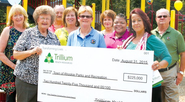 Ahoskie Parks and Recreation director Tina Pritchard (center, in blue) accepts a check for $225,000 from Trillium Health Resources for the construction of a handicap-accessible playground at Miracle on Main Street, the town’s oldest park. Pritchard is joined by (from left)Town Council members Linda Blackburn and Elaine Myers; Bland Baker, Trillium; Ahoskie Chamber director Amy Braswell; Pritchard; Joy Futrell, Trillium; Joan Godwin, Parks & Rec.; Amy Corbitt, Trillium; and Tony Hammond, Town Manager. Staff Photo by Gene Motley