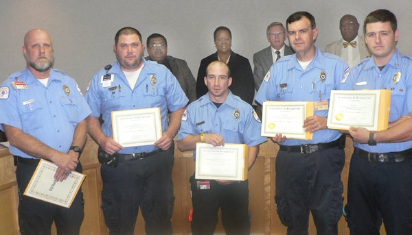The Board of County Commissioners honored a team of Northampton paramedics that won second place in the world (40 countries) for resuscitation skills at a contest in Las Vegas, NV. The paramedics are, from left, EMS Director Charles Joyner (representing paramedic Will Blanchard, who was called away from the meeting on an emergency), Chris Velvin, Joe D’Arco, Supervisor Paul Nowell, and Brandon Rose. The commissioners are, back row from left: Chester Deloatch, Chairwoman Fannie Greene, Joseph Barrett, and Robert Carter. Staff Photo by Keith Hoggard