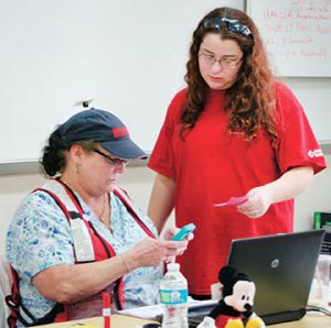 American Red Cross Eastern NC Case Manager Kathy Jones (seated) and fellow ARC Case Worker Courtney Goodson staff the Bertie County DSS Office in Windsor on Tuesday at which they began accepting applications for disaster relief. | Staff Photo by Jennipher Dickens