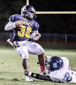 HCHS junior running back Kyeem Perry (#32) attempts to slip through the grasp of Bertie defender Dajour Kemer during Thursday night’s battle in Ahoskie. Perry rushed for a game high 144 yards and scored two touchdowns in the 47-6 win. 