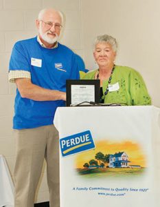 Lewiston-Woodville Mayor Dayle Vaughan presents Jeff Stalls, Director of Operations at the local Perdue processing plant, with a proclamation signifying Feb. 26 as Perdue Day. The plant opened on Feb. 26, 1974.