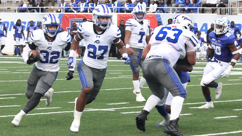 Nijere Peoples (left) follows the blocking of Chowan University teammates Jeremiah Smith (#27) and Daniel Horne (#63) en route to the first of his three rushing touchdowns during Saturday’s CIAA championship game. Staff Photo by Cal Bryant